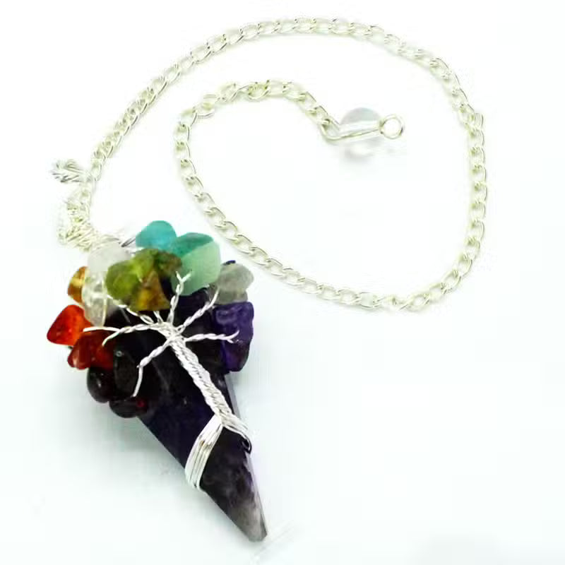 A silver chain necklace featuring a cone-shaped amethyst point pendant wrapped in silver wire, topped with a cluster of multicolored raw gemstone chips including green, red, orange, and purple, on a white background.
