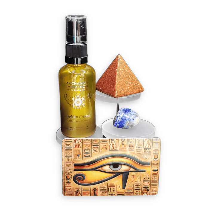 Bottle of Golden citrine spray with pyramid, crystal, and eye of Horus design on a white background